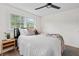 Bright bedroom with a comfortable bed, stylish decor, modern ceiling fan, and natural light, creating a cozy and inviting space at 5774 Scott White Rd, Hollywood, SC 29449