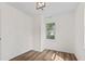 Bright bedroom featuring hardwood floors, white walls, and a modern light fixture, offering a clean and inviting space at 5774 Scott White Rd, Hollywood, SC 29449