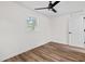 Bedroom features window, closet, ceiling fan, and wood floors at 5774 Scott White Rd, Hollywood, SC 29449