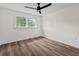 Bedroom features window and a modern ceiling fan above wood floors at 5774 Scott White Rd, Hollywood, SC 29449