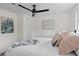 Comfortable bedroom featuring a queen-sized bed with decorative pillows, a modern ceiling fan, and a soft throw blanket at 5774 Scott White Rd, Hollywood, SC 29449