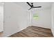 Bedroom features window, closet, ceiling fan, and wood floors at 5774 Scott White Rd, Hollywood, SC 29449