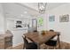 Cozy dining area with an updated light fixture adjacent to a spacious and updated kitchen at 5774 Scott White Rd, Hollywood, SC 29449