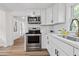 Updated kitchen with stainless steel appliances, white cabinets, and quartz countertops at 5774 Scott White Rd, Hollywood, SC 29449