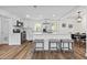 Bright kitchen featuring white cabinets, stainless steel appliances, and a spacious island with seating at 5774 Scott White Rd, Hollywood, SC 29449