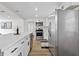 Modern kitchen featuring white cabinets, stainless steel appliances, and a spacious quartz countertop island at 5774 Scott White Rd, Hollywood, SC 29449