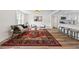 Beautifully furnished living room featuring an open layout, modern decor, wood floors, and a seamless transition to the kitchen at 5774 Scott White Rd, Hollywood, SC 29449