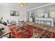 Inviting living room featuring an open layout, modern decor, wood floors, and a seamless transition to the kitchen at 5774 Scott White Rd, Hollywood, SC 29449