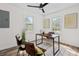 Bright home office features two windows and a modern ceiling fan above wood floors at 5774 Scott White Rd, Hollywood, SC 29449