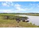 The waterway sits next to a grassy yard with a broken deck and a grill for cookouts by the water at 6240 Old Point Rd # C-8, Hanahan, SC 29410