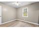 Bright, neutral bedroom features a ceiling fan and hardwood floors at 6240 Old Point Rd # C-8, Hanahan, SC 29410