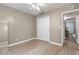 Neutral bedroom features a closet and a view to the hallway with hardwood floors at 6240 Old Point Rd # C-8, Hanahan, SC 29410