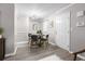 Bright dining room with a modern chandelier, table for four, light gray walls, and light wood-look flooring at 6240 Old Point Rd # C-8, Hanahan, SC 29410