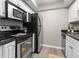 Bright kitchen featuring white cabinets, stainless steel appliances, granite countertops, and light wood-look flooring at 6240 Old Point Rd # C-8, Hanahan, SC 29410