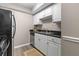 Efficient kitchen featuring white cabinets, stainless steel appliances, and granite countertops with a jute rug at 6240 Old Point Rd # C-8, Hanahan, SC 29410