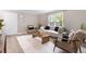 Bright living room featuring a modern sofa, decorative rug, stylish chairs, and natural light from a large window at 6240 Old Point Rd # C-8, Hanahan, SC 29410
