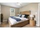 Comfortable main bedroom with a wooden headboard, ceiling fan, and large window for ample natural light at 6240 Old Point Rd # C-8, Hanahan, SC 29410