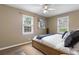 Cozy main bedroom featuring a bed, a ceiling fan, and dual windows that provide ample natural light at 6240 Old Point Rd # C-8, Hanahan, SC 29410