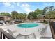 The community pool features lounge chairs and a view of the surrounding community at 6240 Old Point Rd # C-8, Hanahan, SC 29410