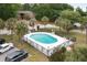 Aerial view of community pool surrounded by palm trees and lounge chairs on a sunny day at 6240 Old Point Rd # C-8, Hanahan, SC 29410