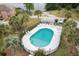 Aerial view of a fenced community pool with palm trees and lounge chairs on a sunny day at 6240 Old Point Rd # C-8, Hanahan, SC 29410