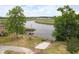 Scenic waterfront area with a boat launch, dock, seating, and grill at 6240 Old Point Rd # C-8, Hanahan, SC 29410