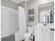 A bathroom featuring a tub and shower combination, white vanity, and a framed mirror at 725 Pepperbush St, Charleston, SC 29414