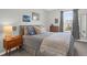 A bedroom with a cozy bed, mid-century modern furniture, and natural light at 725 Pepperbush St, Charleston, SC 29414