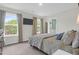 A bedroom boasting natural light, a flat-screen TV, and an ensuite bathroom at 725 Pepperbush St, Charleston, SC 29414