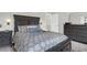 A bedroom featuring a dark wood bed set, decorative pillows, and an ensuite bathroom at 725 Pepperbush St, Charleston, SC 29414