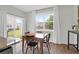 Dining area with wood table, black chairs, sliding glass doors, and backyard views at 725 Pepperbush St, Charleston, SC 29414