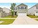 Charming two-story home featuring a two-car garage and well-manicured front lawn at 725 Pepperbush St, Charleston, SC 29414