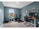 A home gym with an exercise bike, desk, and window with views at 725 Pepperbush St, Charleston, SC 29414