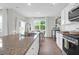 Granite countertop with island sink, stainless faucet, leading into an adjacent dining area at 725 Pepperbush St, Charleston, SC 29414