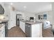 Bright kitchen with granite countertops, island with sink, stainless appliances, and connecting living area at 725 Pepperbush St, Charleston, SC 29414