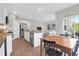 Open kitchen with granite counters, stainless appliances, and island sink flowing into the dining and living area at 725 Pepperbush St, Charleston, SC 29414