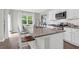 Bright kitchen with granite counters, subway tile backsplash, stainless appliances, and island seating at 725 Pepperbush St, Charleston, SC 29414