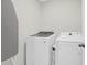 A well-equipped laundry room with modern appliances and an ironing board at 725 Pepperbush St, Charleston, SC 29414