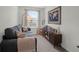 Cozy sitting room with a gray sofa, modern bookcase, and natural light from a nearby window at 725 Pepperbush St, Charleston, SC 29414