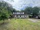 Inviting two-story home with a lush green lawn and mature trees providing ample shade at 759 Powhatan Ave, Mount Pleasant, SC 29464