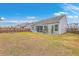 Backyard with lawn, rear house exterior and a fire pit with privacy fencing at 7690 High Maple Cir, North Charleston, SC 29418