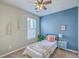 Charming bedroom with a single bed, blue accent wall, natural light, and decorative accents at 7690 High Maple Cir, North Charleston, SC 29418
