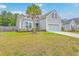 Charming home exterior featuring a well-manicured lawn, a two-car garage, and attractive curb appeal at 7690 High Maple Cir, North Charleston, SC 29418