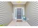 Inviting front entrance with a dark door, decorative accents and a welcoming porch sign at 7690 High Maple Cir, North Charleston, SC 29418