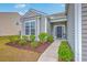 Inviting front porch with decorative accents and well-maintained landscaping, offering a warm welcome to the home at 7690 High Maple Cir, North Charleston, SC 29418