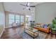 Bright and spacious living room with hardwood floors, ample natural light, and comfortable seating arrangements at 7690 High Maple Cir, North Charleston, SC 29418