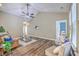 Open-concept living room with vaulted ceilings, hardwood floors, and seamless flow into the dining area at 7690 High Maple Cir, North Charleston, SC 29418