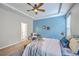 Bright main bedroom showcasing a tray ceiling, blue accent wall, and decorative wall art at 7690 High Maple Cir, North Charleston, SC 29418