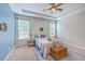 Serene main bedroom with natural light, tray ceilings, and a queen sized bed with stylish decor at 7690 High Maple Cir, North Charleston, SC 29418