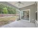 Relaxing screened porch overlooking a private backyard with lush greenery and a fire pit at 7690 High Maple Cir, North Charleston, SC 29418